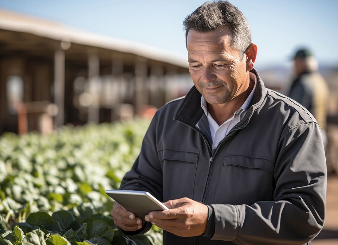 Read Our Reviews - Farmer Using Tablet at a Farm on a Sunny Day